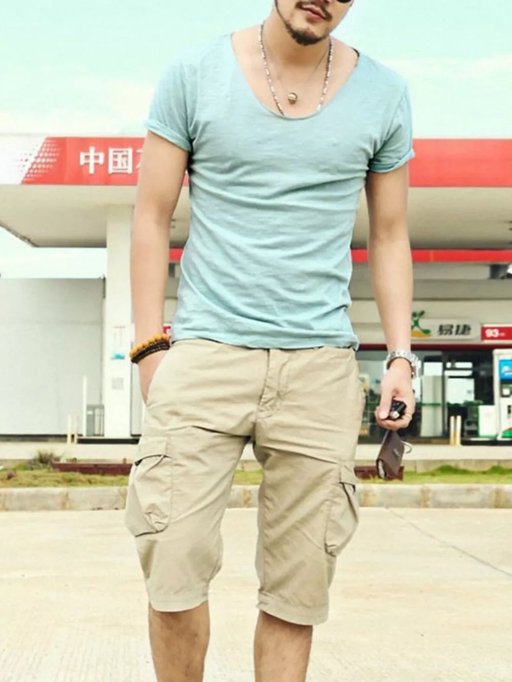 Men's light blue cotton relaxed scoop neck t-shirt with rolled sleeves.