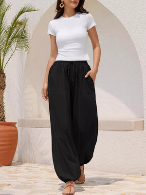 Black relaxed harem pants with drawstring and contrast stitching detail