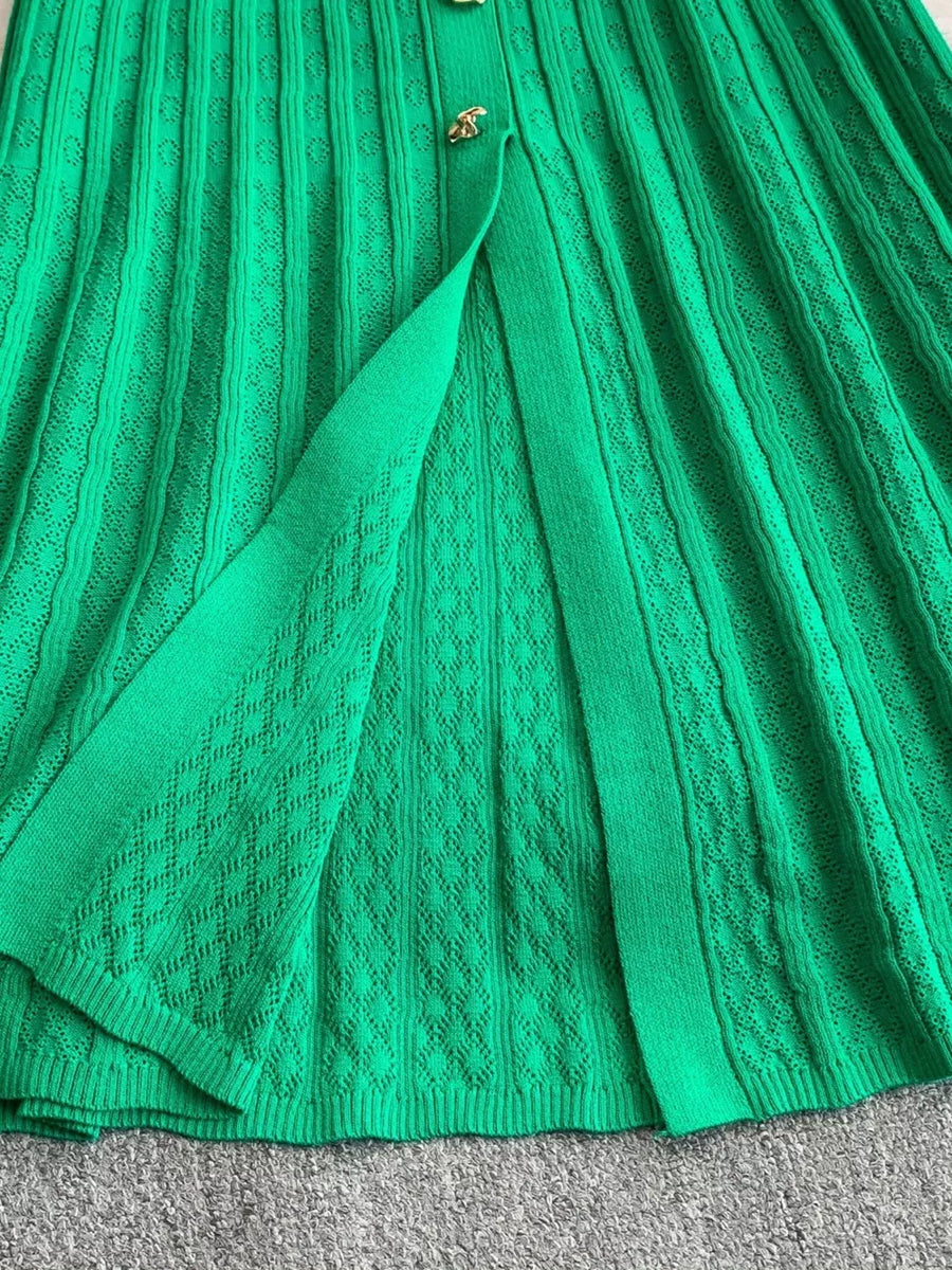 Green ribbed knit midi dress with button detail and open front slit.