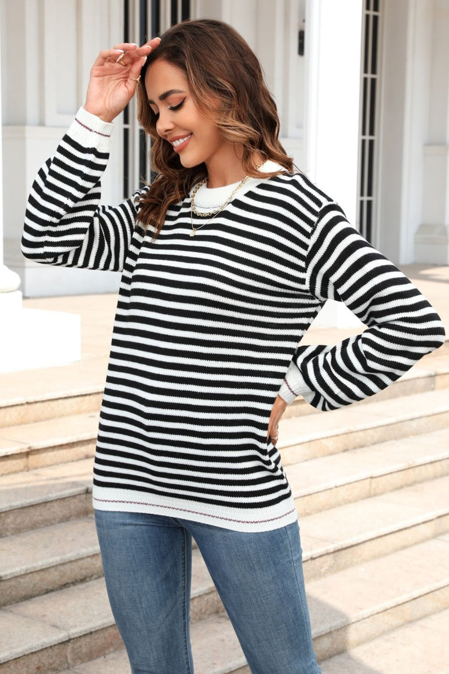 Black and white striped crewneck sweater with crew neckline and long sleeves.
