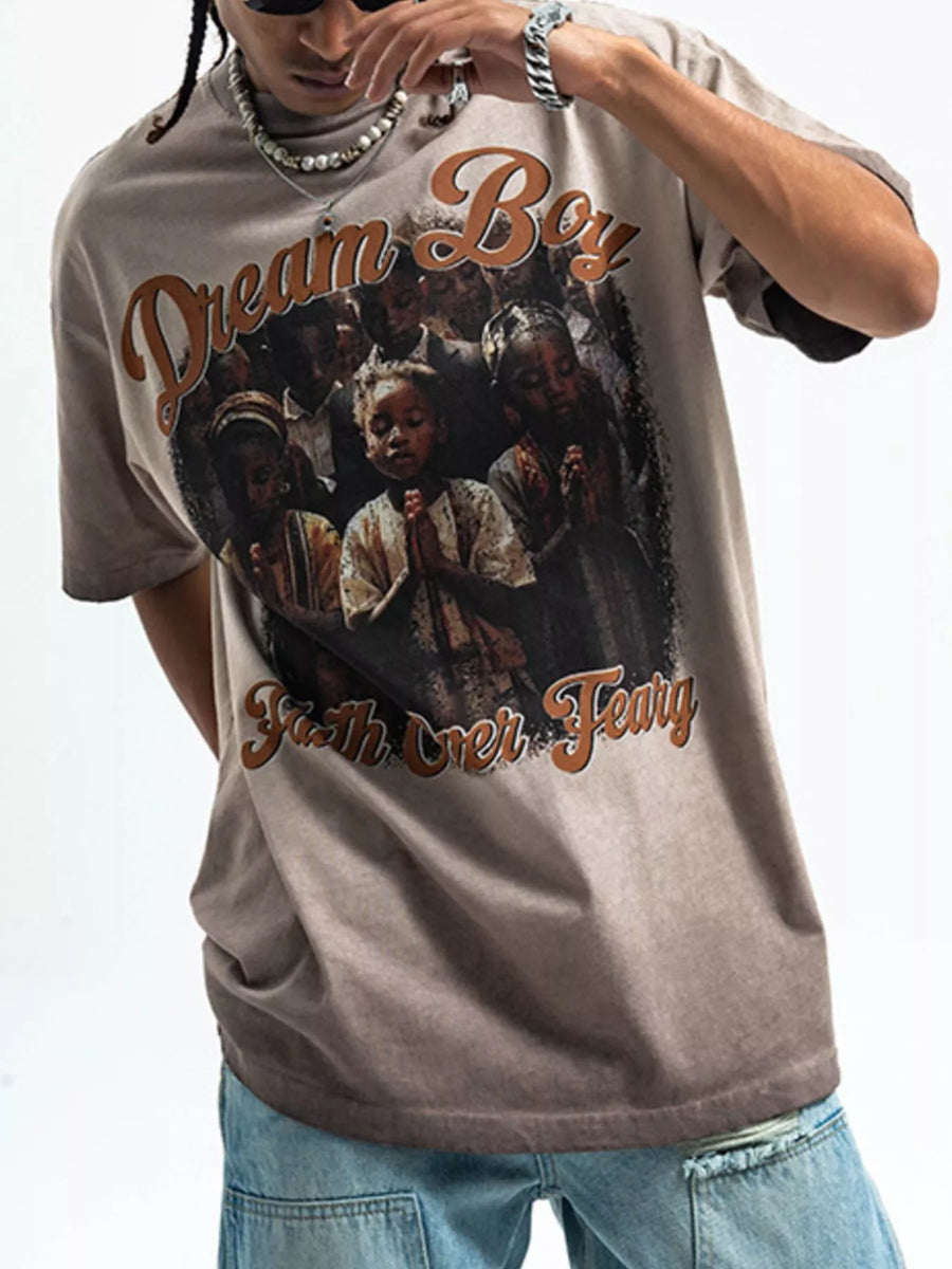 Khaki graphic t-shirt with puff sleeves and a "Dream Boy Faith Over Fear" print.