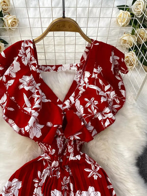 Red floral print cotton romper with ruffled sleeves and smocked waist