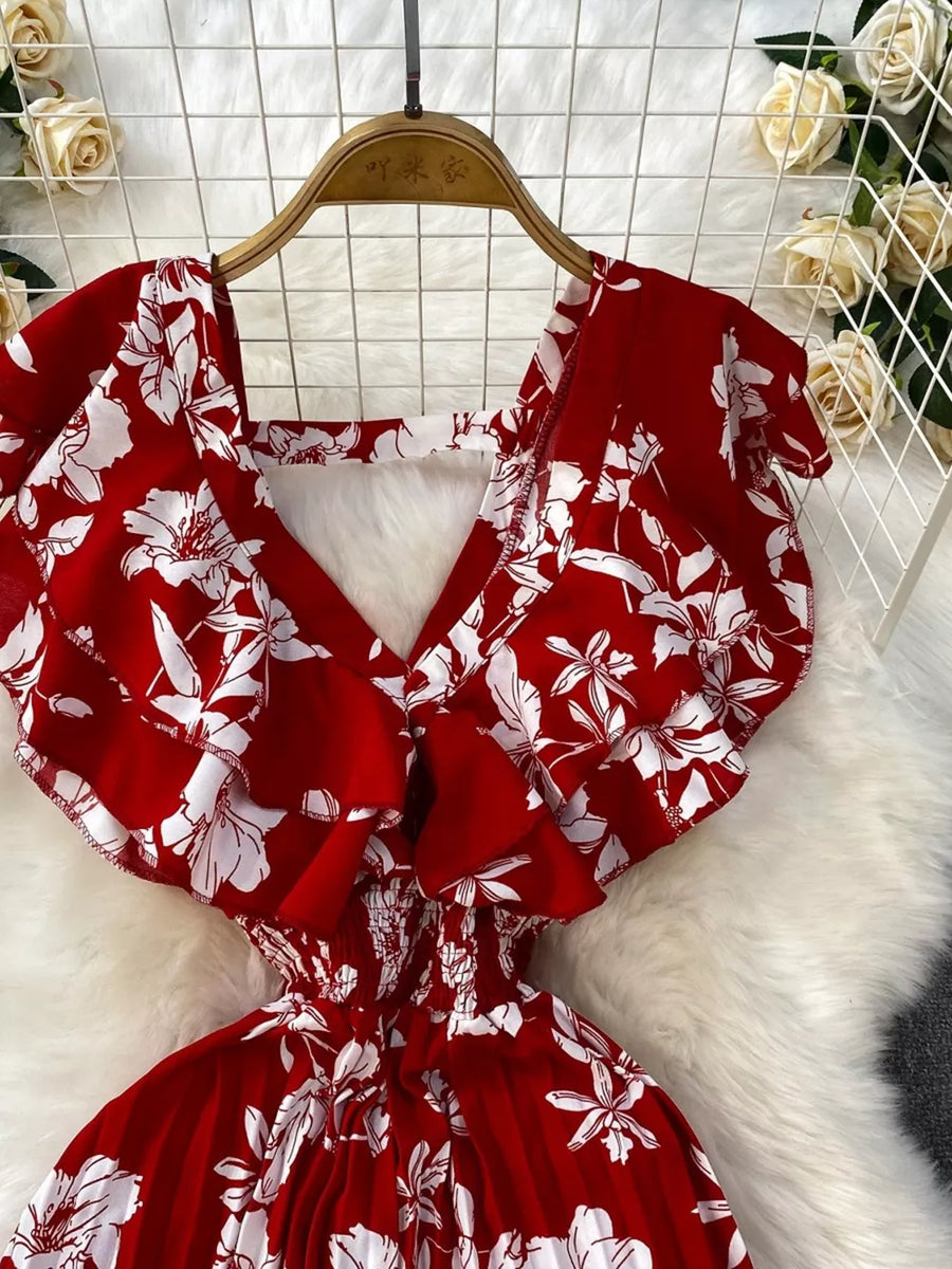 Red floral print cotton romper with ruffled sleeves and smocked waist