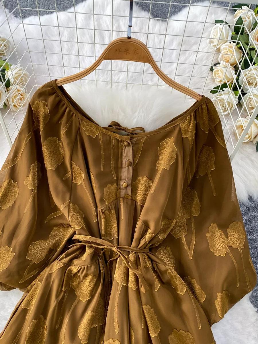 Brown chiffon maxi dress with floral embroidery, tie waist, and button-down front.