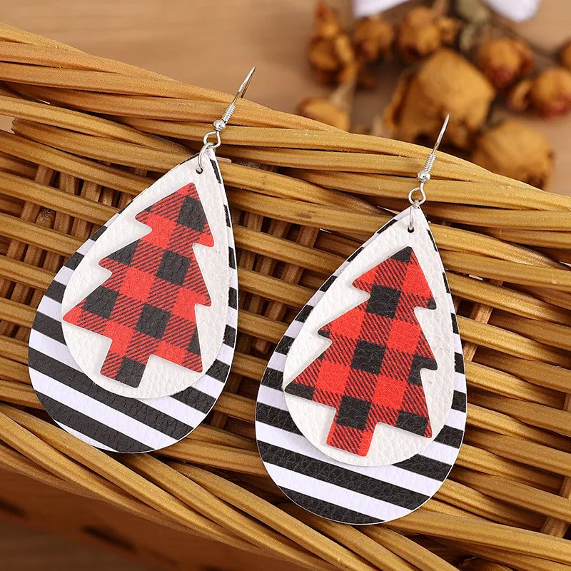 Plaid tree teardrop earrings with black and white stripes, faux leather material.