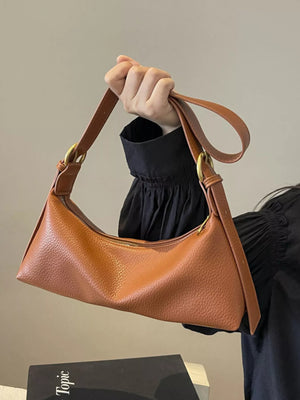 Minimalist brown PU leather crossbody bag with adjustable strap and gold hardware.
