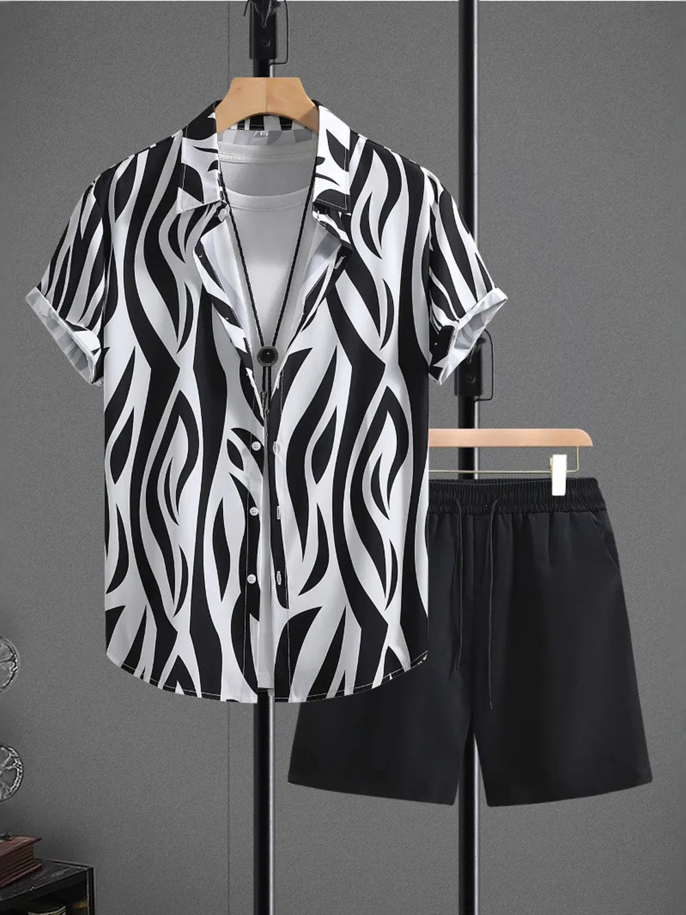Black and white zebra print short sleeve button-up shirt with black drawstring shorts.