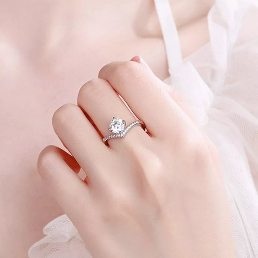Dazzling sterling silver ring with brilliant moissanite stone and pave band.