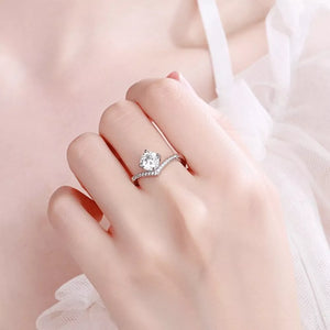 Dazzling sterling silver ring with brilliant moissanite stone and pave band.