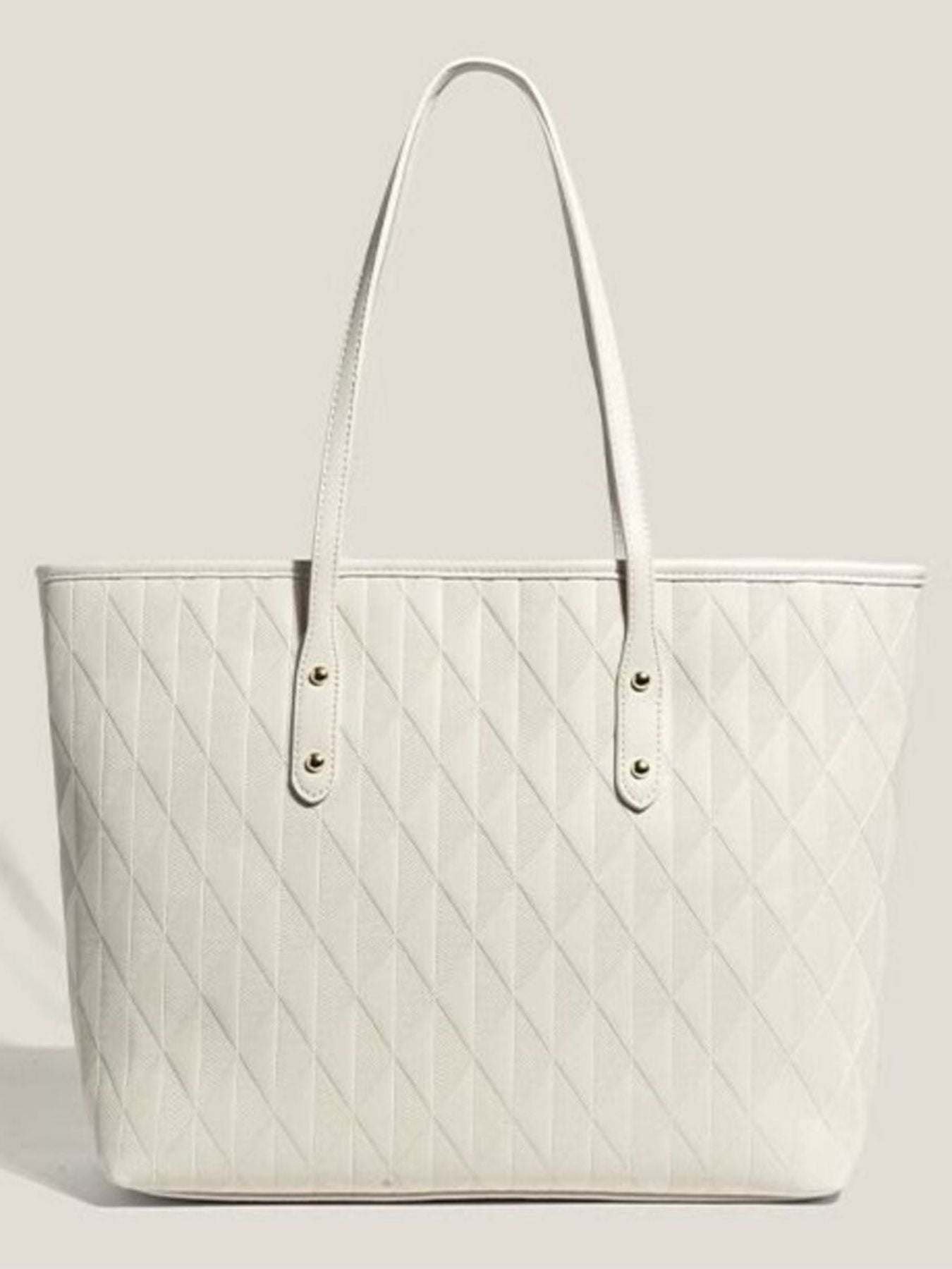 White quilted pu leather tote bag with diamond pattern and gold stud details.