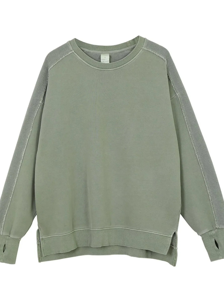 Sage oversized sweatshirt with raw-edge seams and thumbholes.