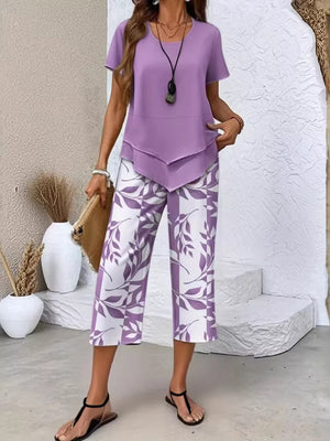 Lavender tiered short sleeve top with purple leaf print cropped pants.