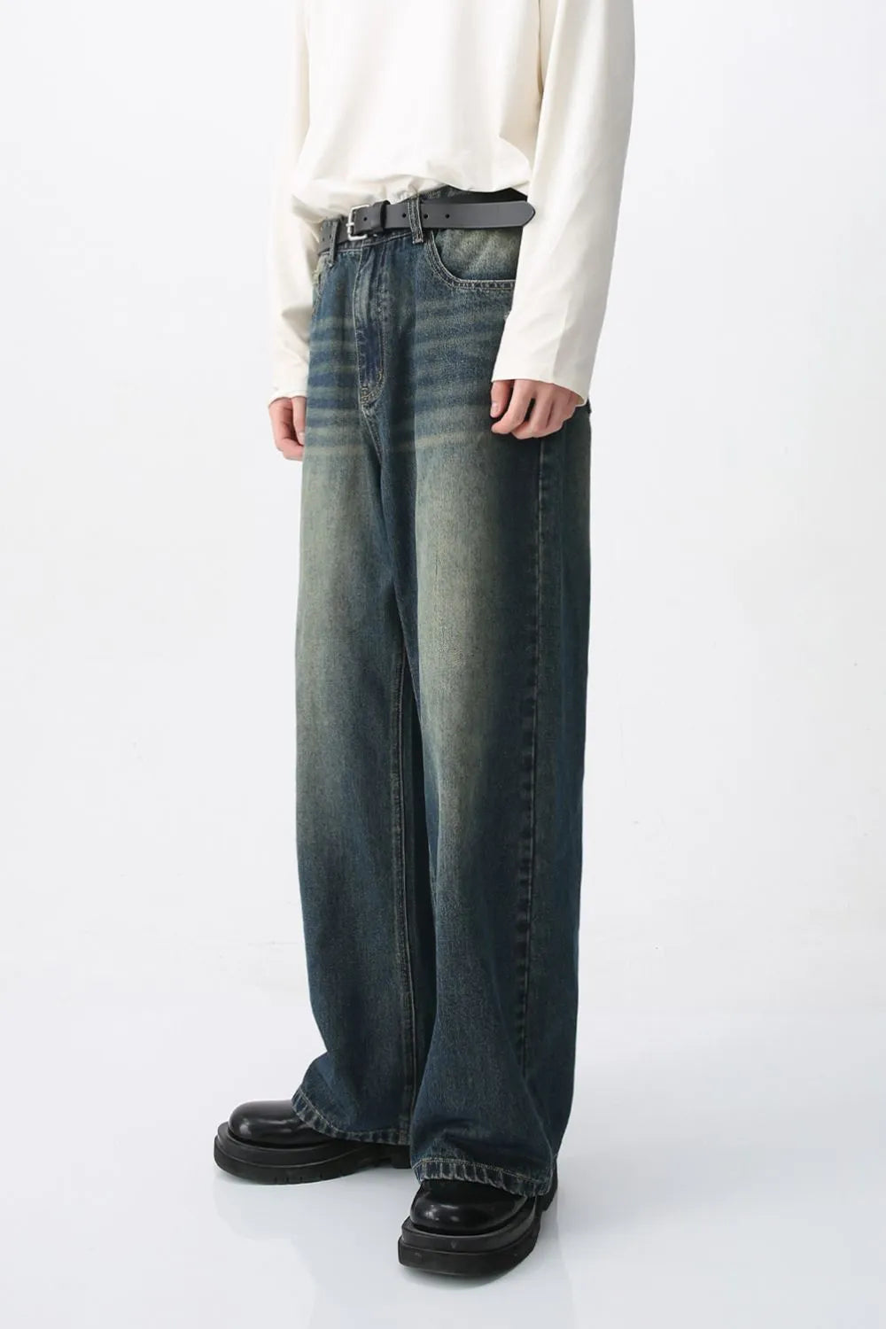Faded wash wide-leg denim jeans in medium color, featuring a relaxed fit and distressed details.