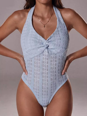 Light blue lace halter bodysuit with twisted front detail and intricate pattern.