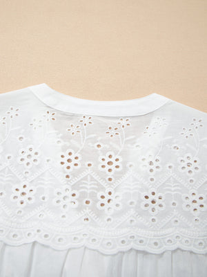 White cotton sheer shirt with floral eyelet embroidery and a button-down collar.