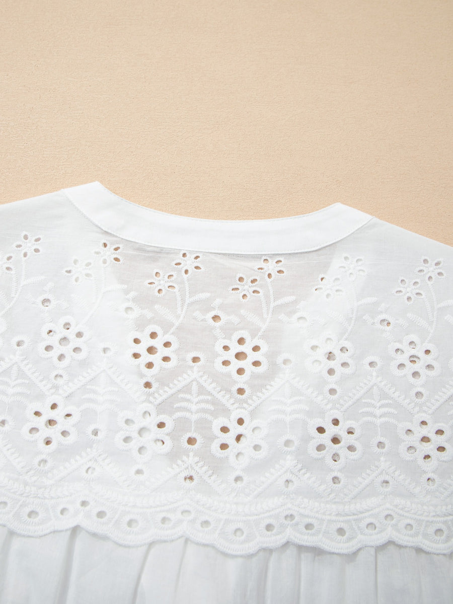 White cotton sheer shirt with floral eyelet embroidery and a button-down collar.