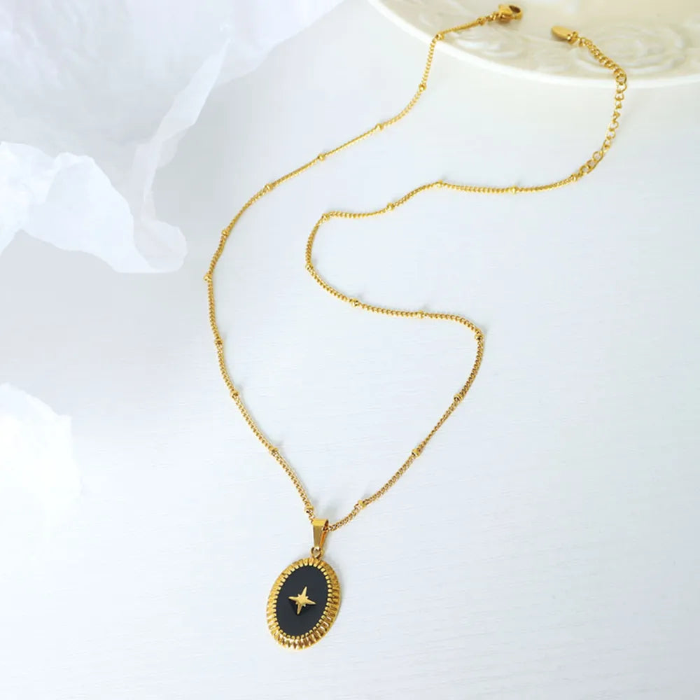 Gold celestial starburst oval pendant necklace with beaded chain.