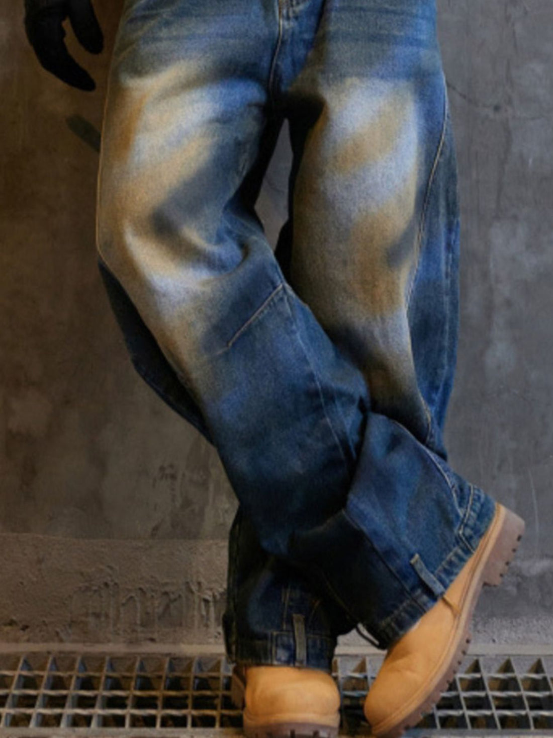 Men's blue cotton distressed wide-leg jeans with a baggy fit.