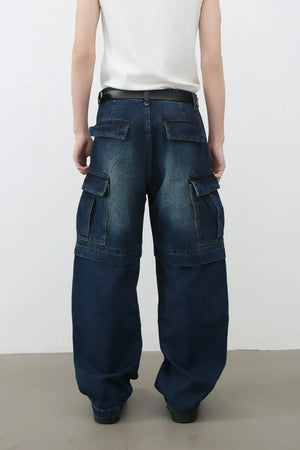 Dark denim cargo pants with layered pockets and a relaxed fit.