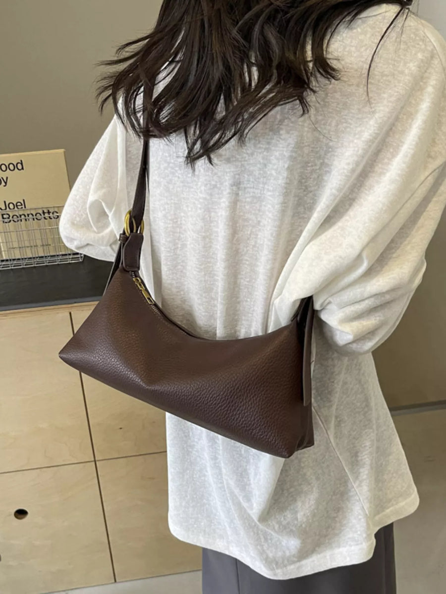 Brown minimalist PU leather crossbody bag with adjustable strap and gold hardware.