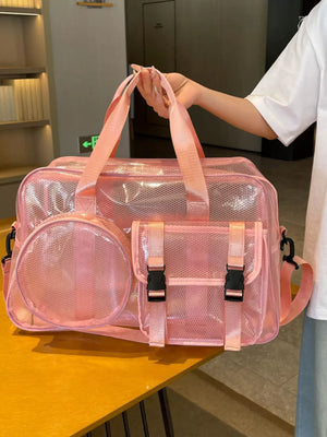 Pink PVC travel organizer bag with multiple pockets and buckle closures.