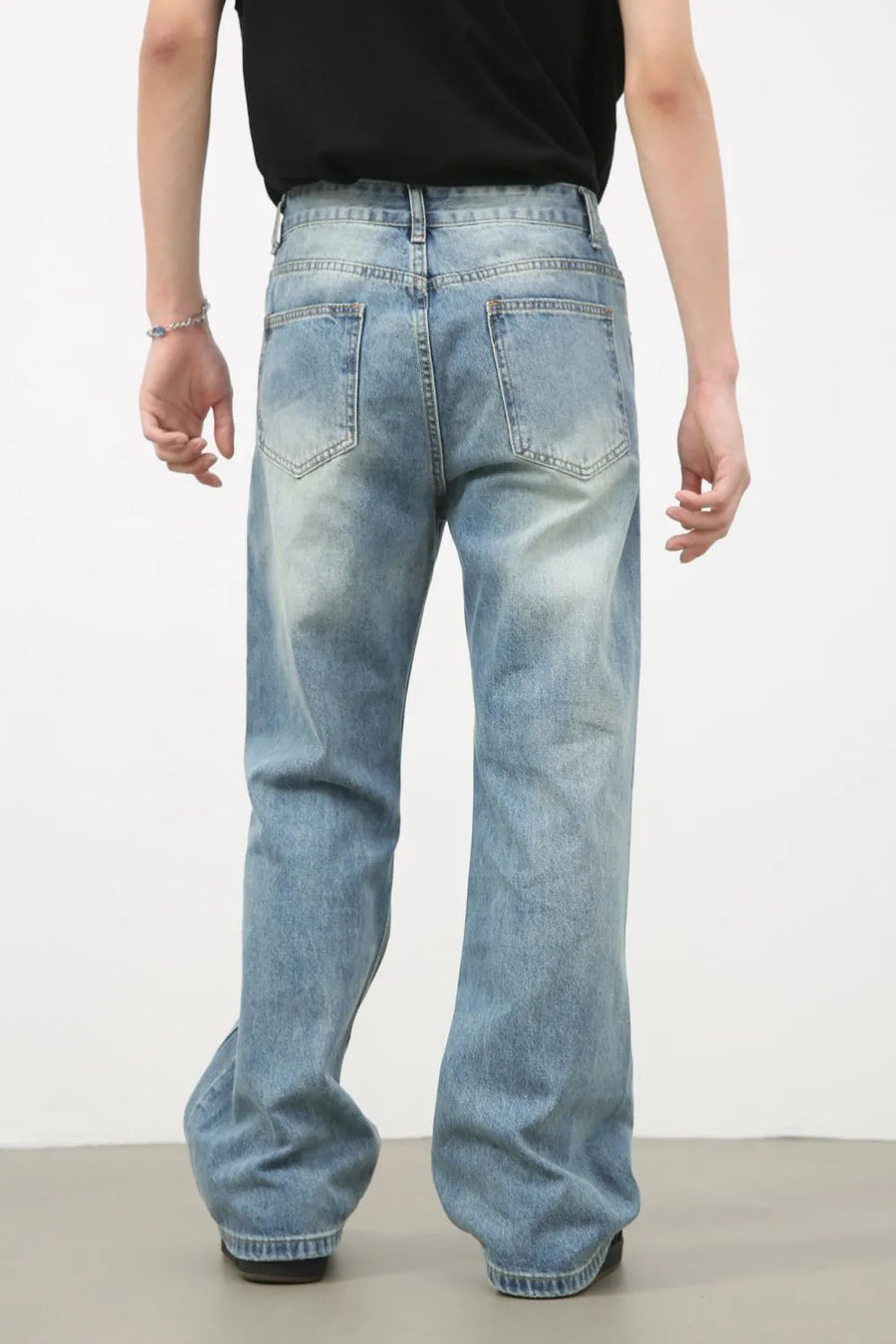 Distressed flare-leg denim jeans in medium wash cotton with a relaxed fit.