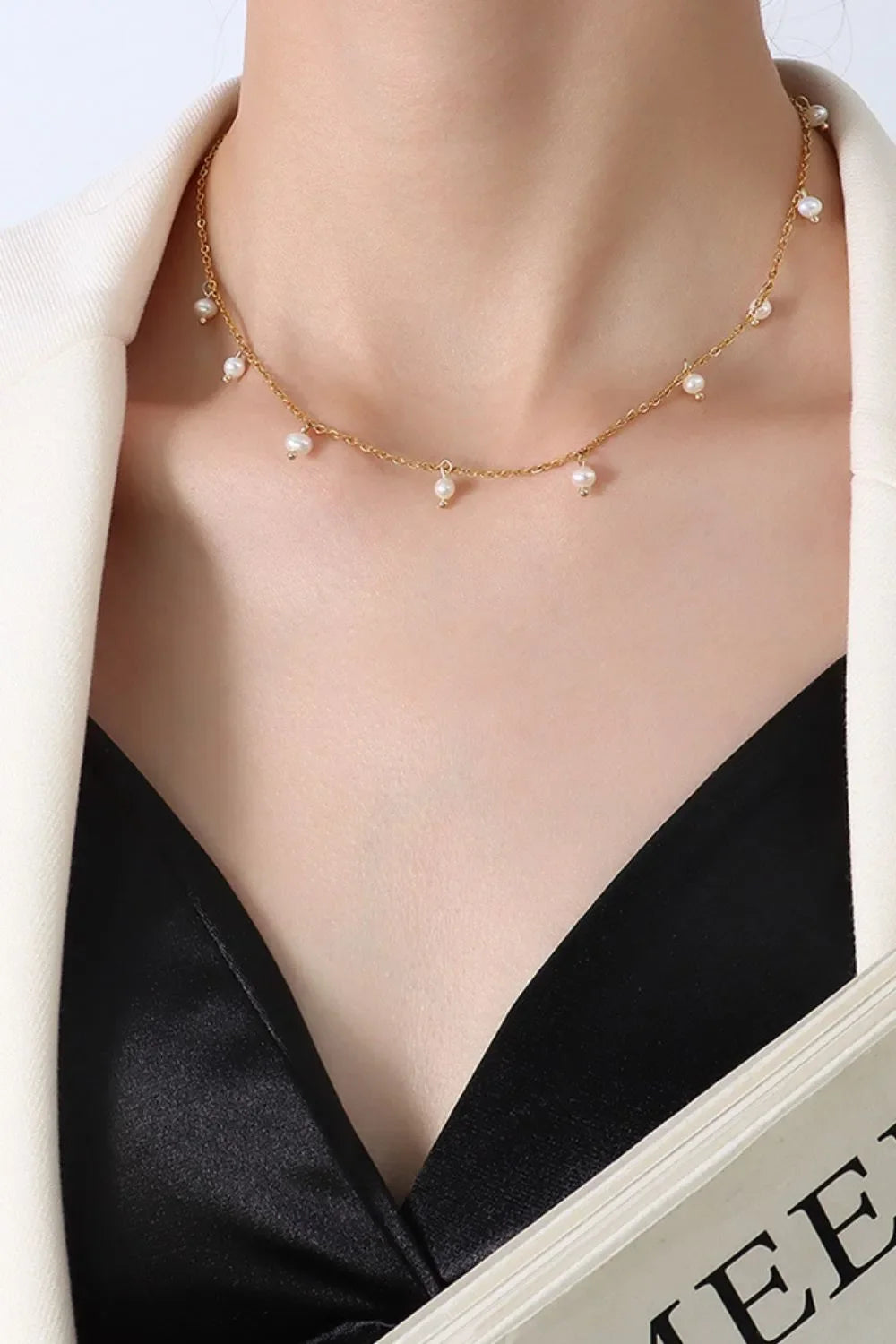 Gold chain necklace with dangling pearl accents