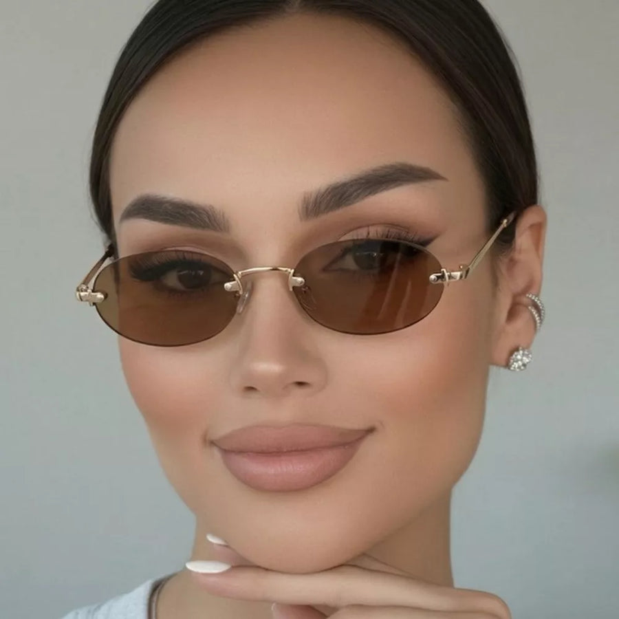 metal Frame material: Metal Lens material: Polycarbonate Temple material: Metal sunglasses in Tan with oval silhouette
