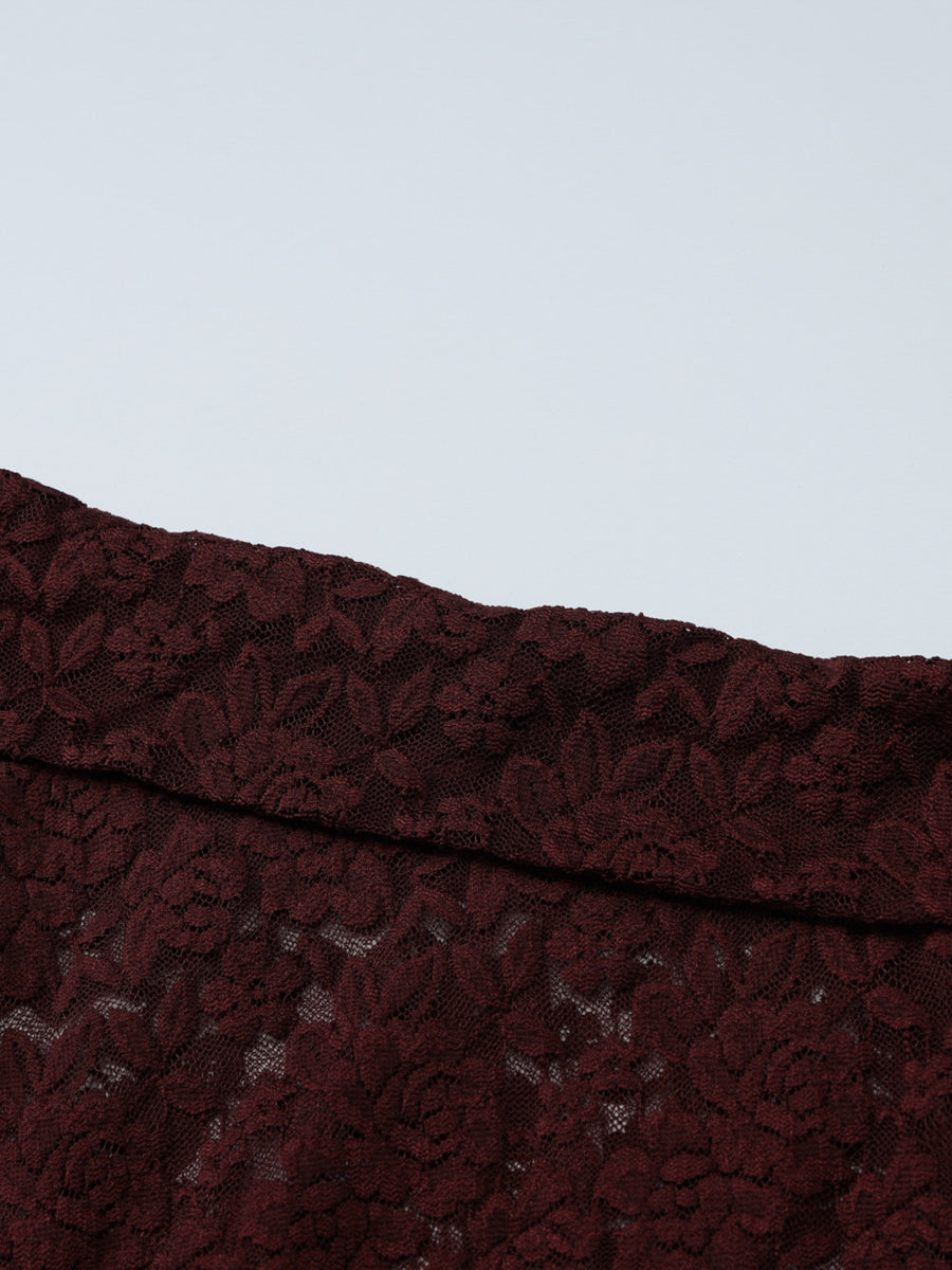 Sheer lace one-shoulder top in burgundy with floral pattern.