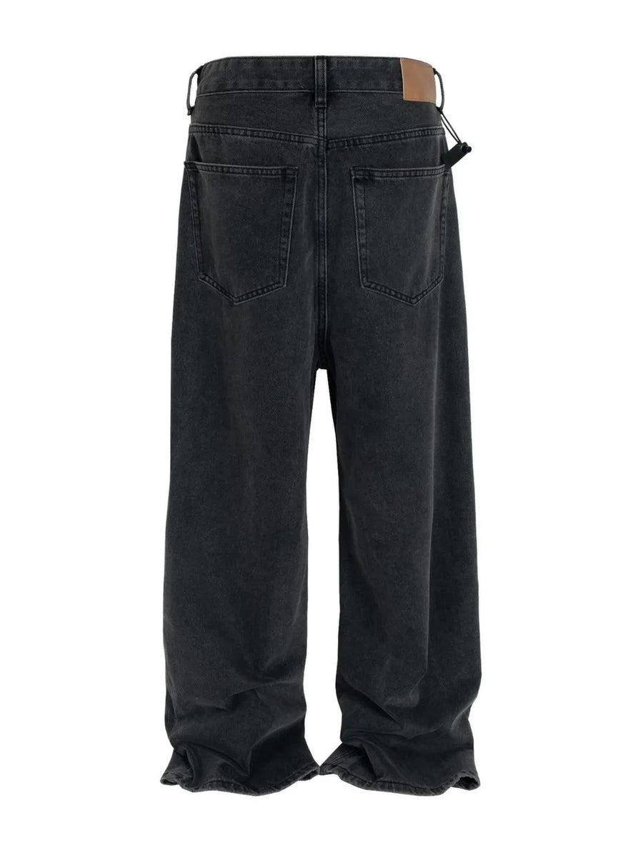 Baggy dark wash denim jeans with a sculpted hemline and a drawstring detail.
