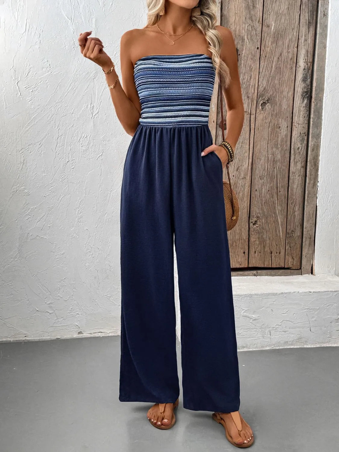 Striped bandeau palazzo jumpsuit in dark blue with wide legs and pockets.