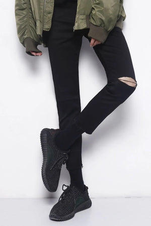 Distressed knee skinny jeans in dark cotton with a ripped detail on the left knee.