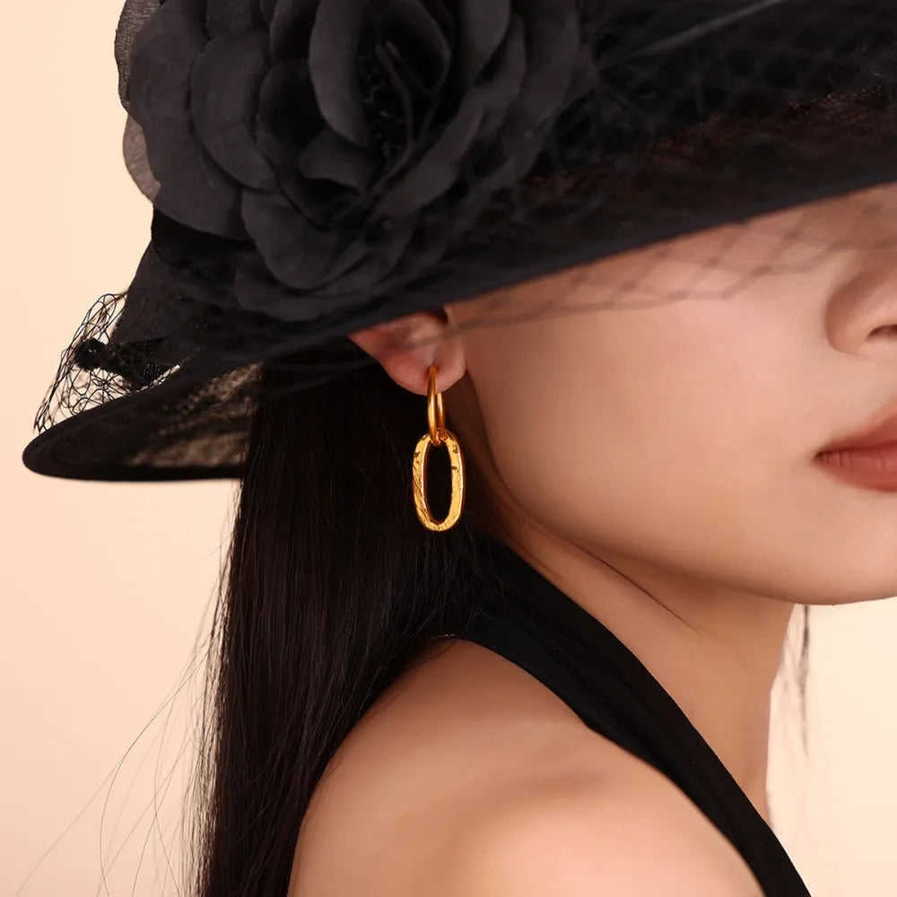 Textured gold vermeil oval hoop earrings with a subtle hammered finish.