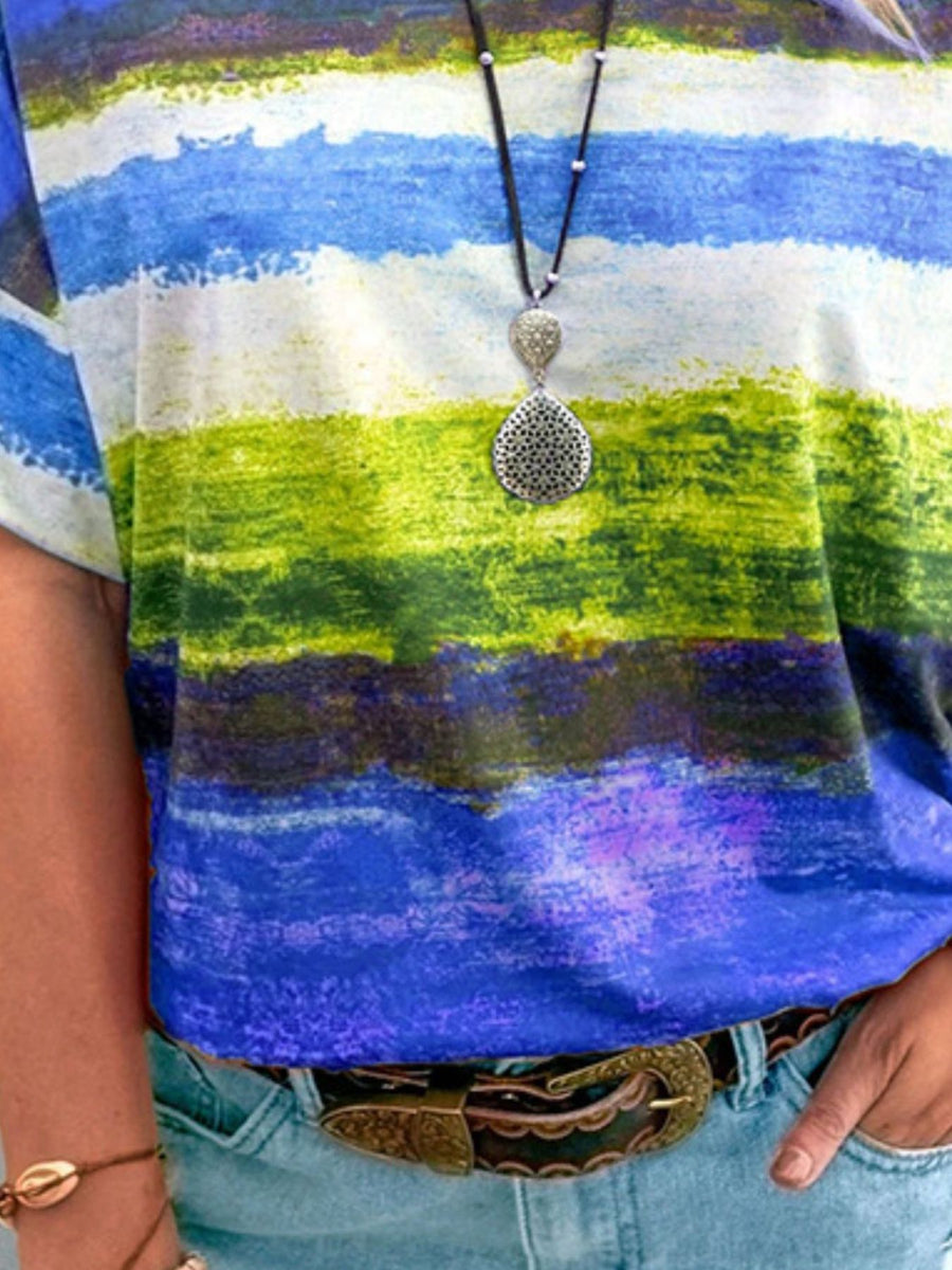 Casual t-shirt with brushstroke stripes in blue, green, and purple.
