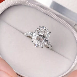 Elegant moissanite oval ring in sterling silver with pave band