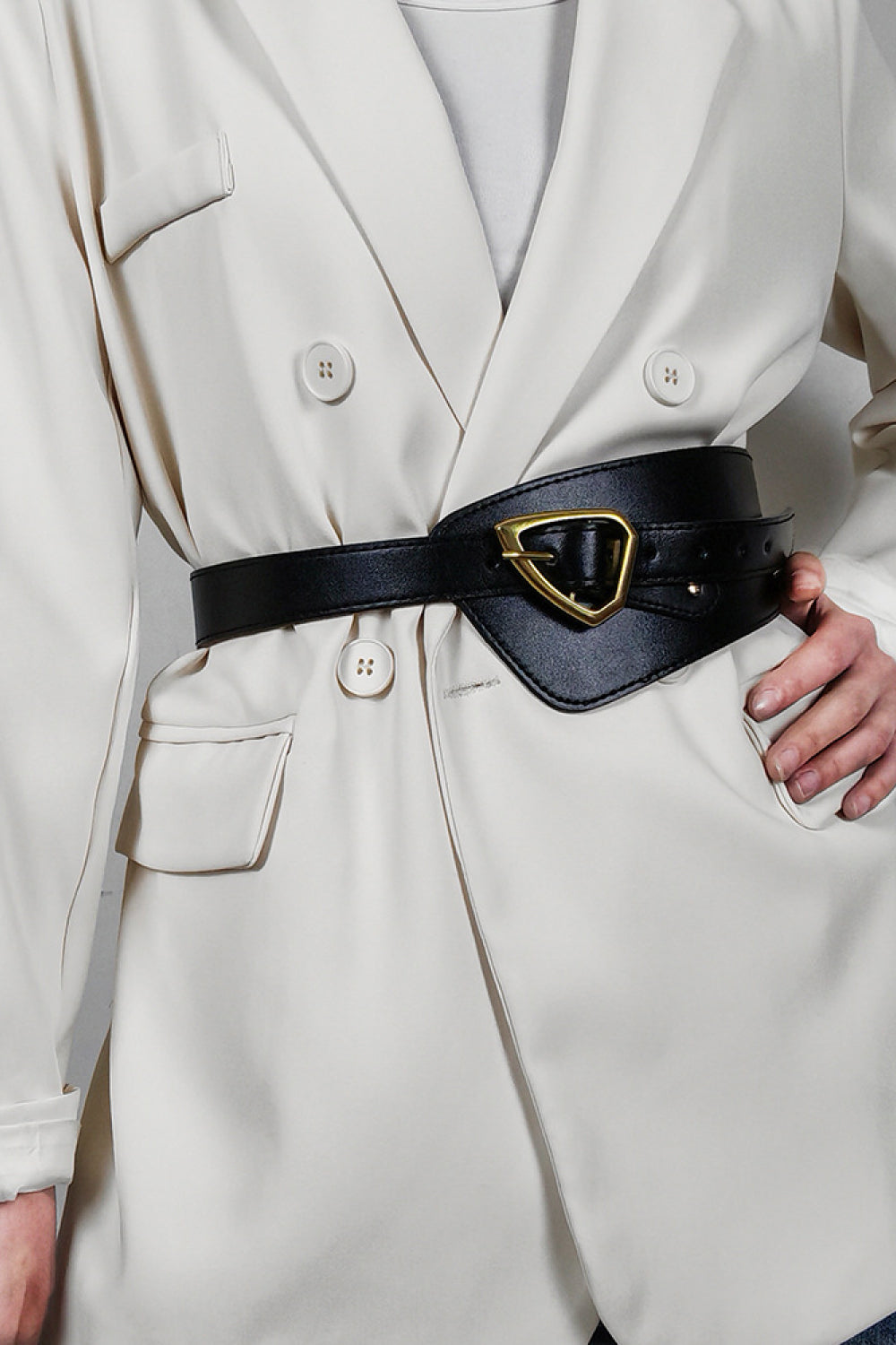 Black leather waist belt with gold buckle and asymmetric detail
