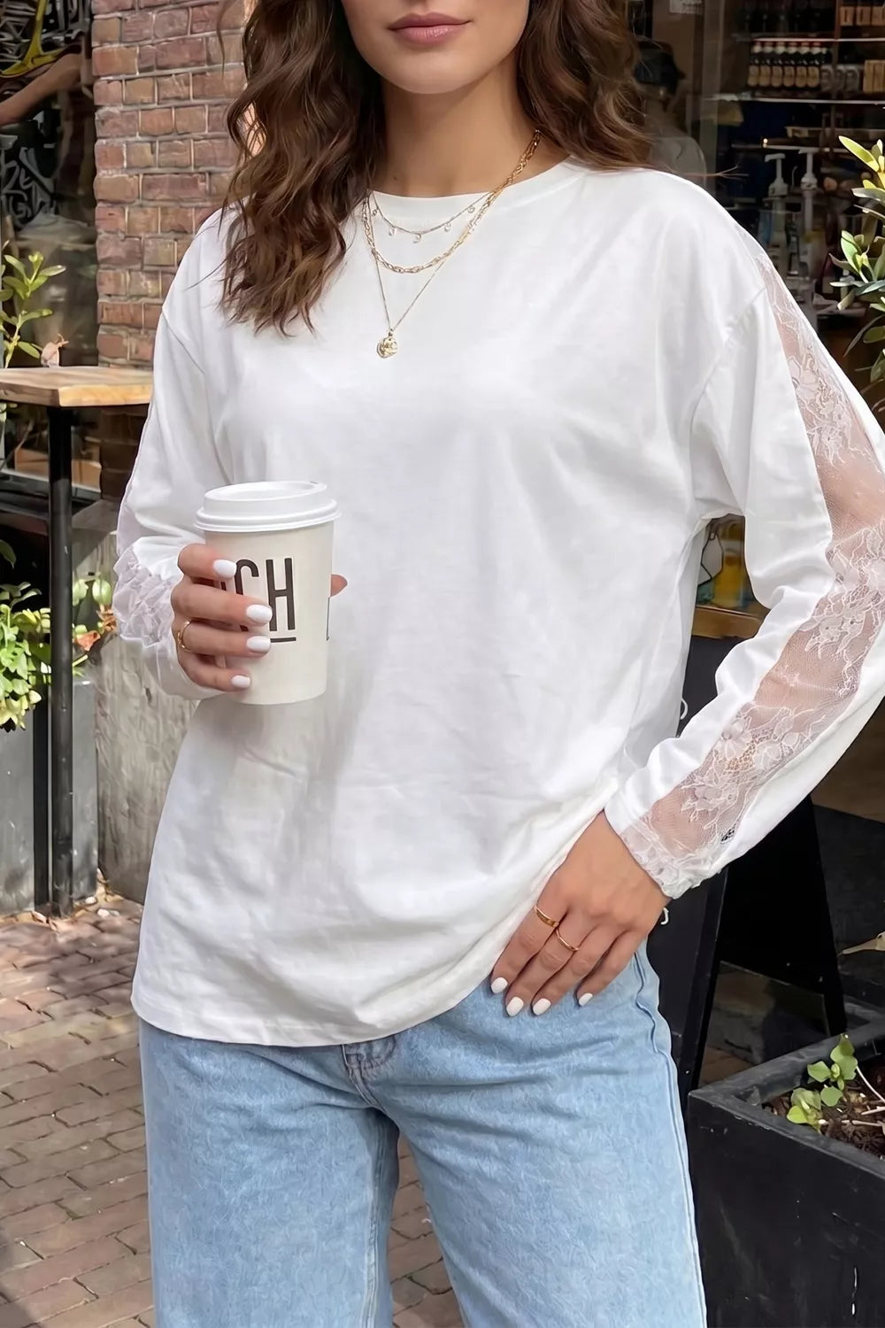 White long sleeve crew neck shirt with delicate lace panel sleeves.