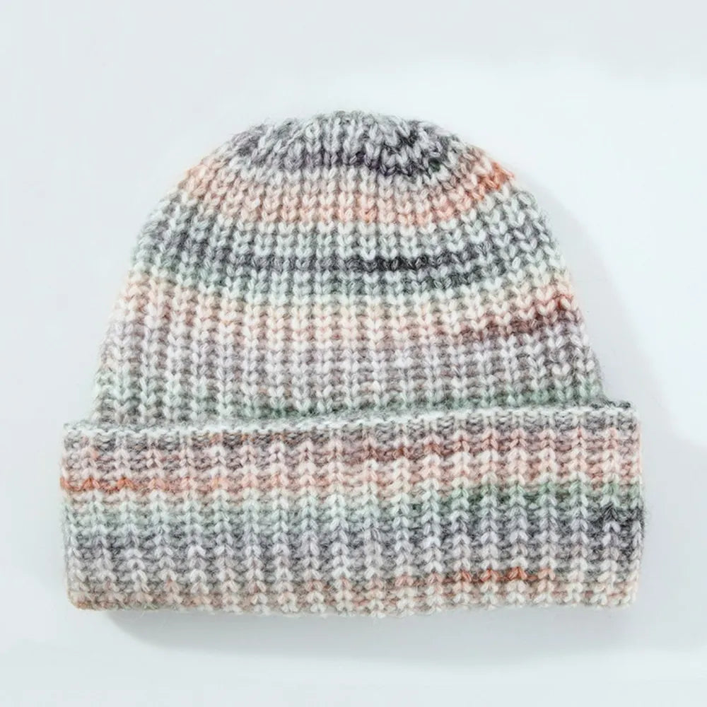 Textured mélange ribbed beanie in multi-color with a folded brim.