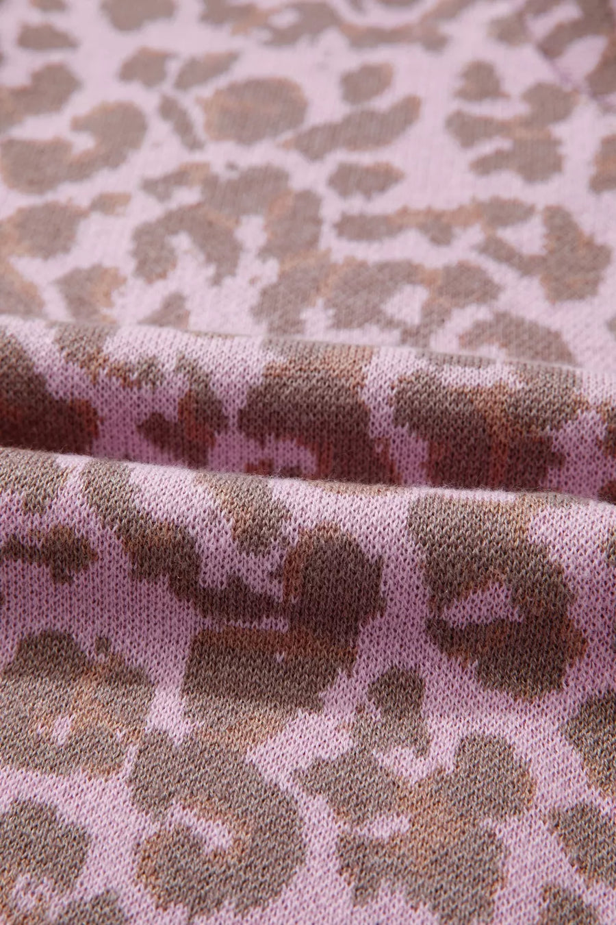 Pink knit fabric with brown leopard print