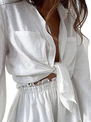 White linen two-piece set with tie-front shirt and ruffled waist shorts
