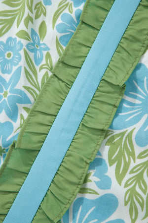 Floral ruffled maternity blouse with blue flowers and green leaves, featuring a blue ribbon detail.