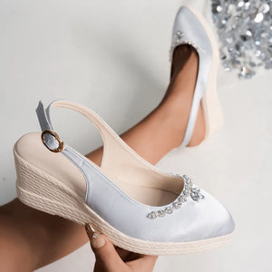 Light gray satin slingback espadrille wedges with rhinestone embellishments and buckle strap.