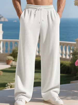 Men's white ribbed drawstring sweatpants with a relaxed fit and wide leg.