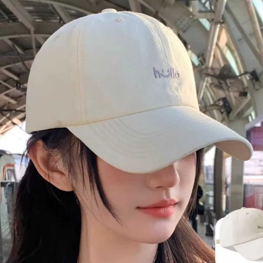 Beige cotton baseball cap with embroidered "hello" detail