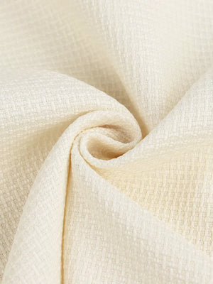 Cream textured woven fabric with a subtle diamond pattern.