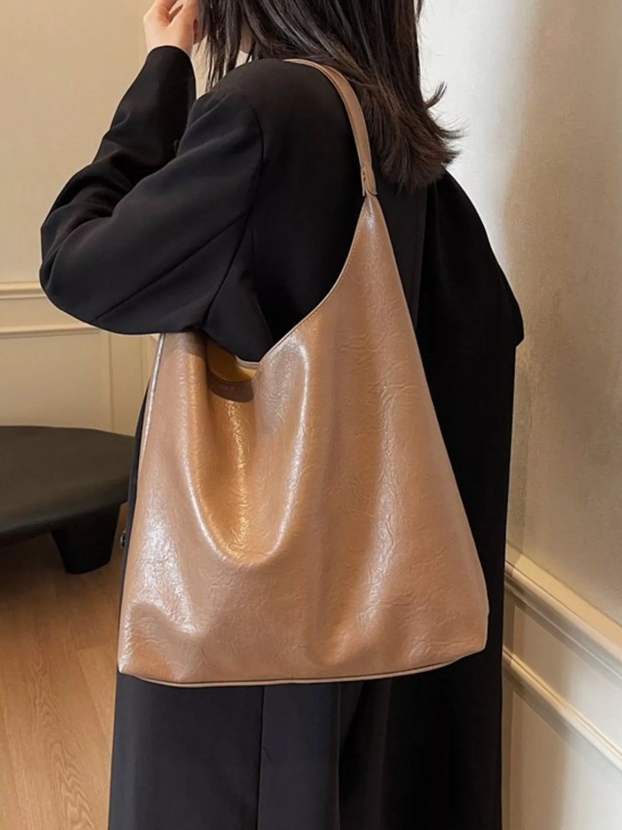 Sculptural PU leather tote bag in coffee color with a slouchy silhouette and single strap.