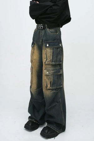 Faded wash oversized cargo jeans in dark blue denim with multiple button flap pockets and a baggy fit.