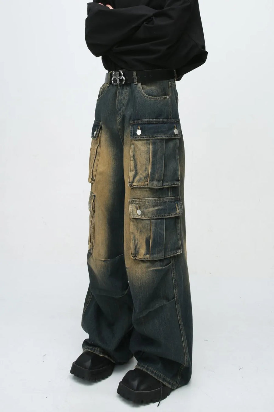 Faded wash oversized cargo jeans in dark blue denim with multiple button flap pockets and a baggy fit.