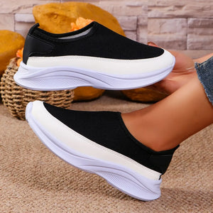Black mesh slip-on sneakers with white stripe detail and platform sole.
