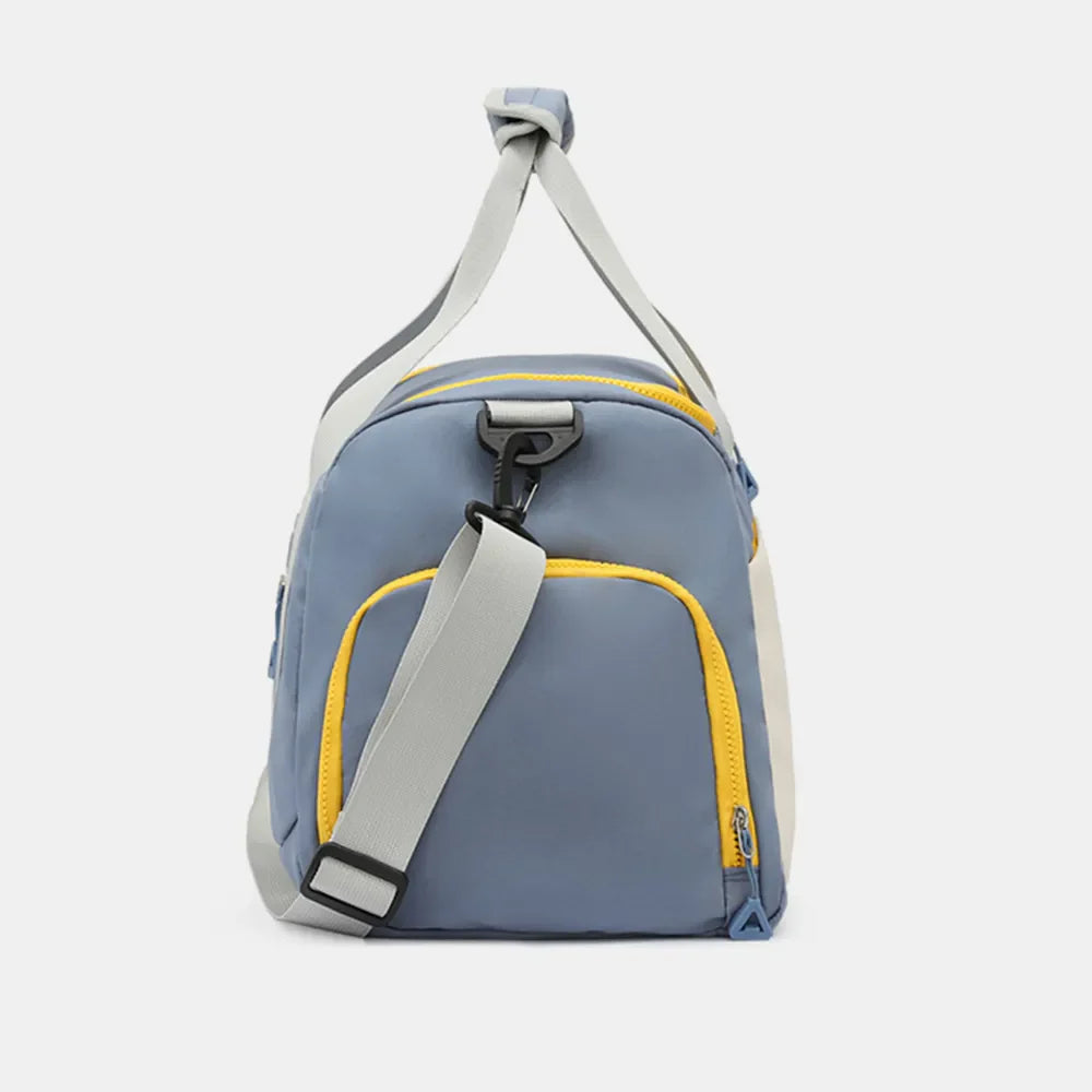 Colorblock gym duffel bag in Dusty Blue with yellow trim and grey straps.